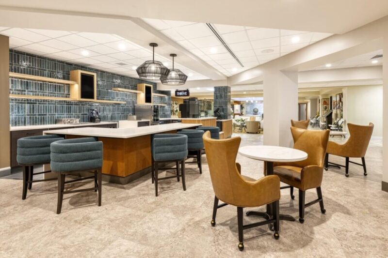 Custom millwork island and cabinetry for healthcare dining and lounge area by Castaldi Custom